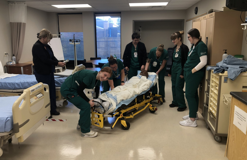 Chatham nursing students in room with stretcher
